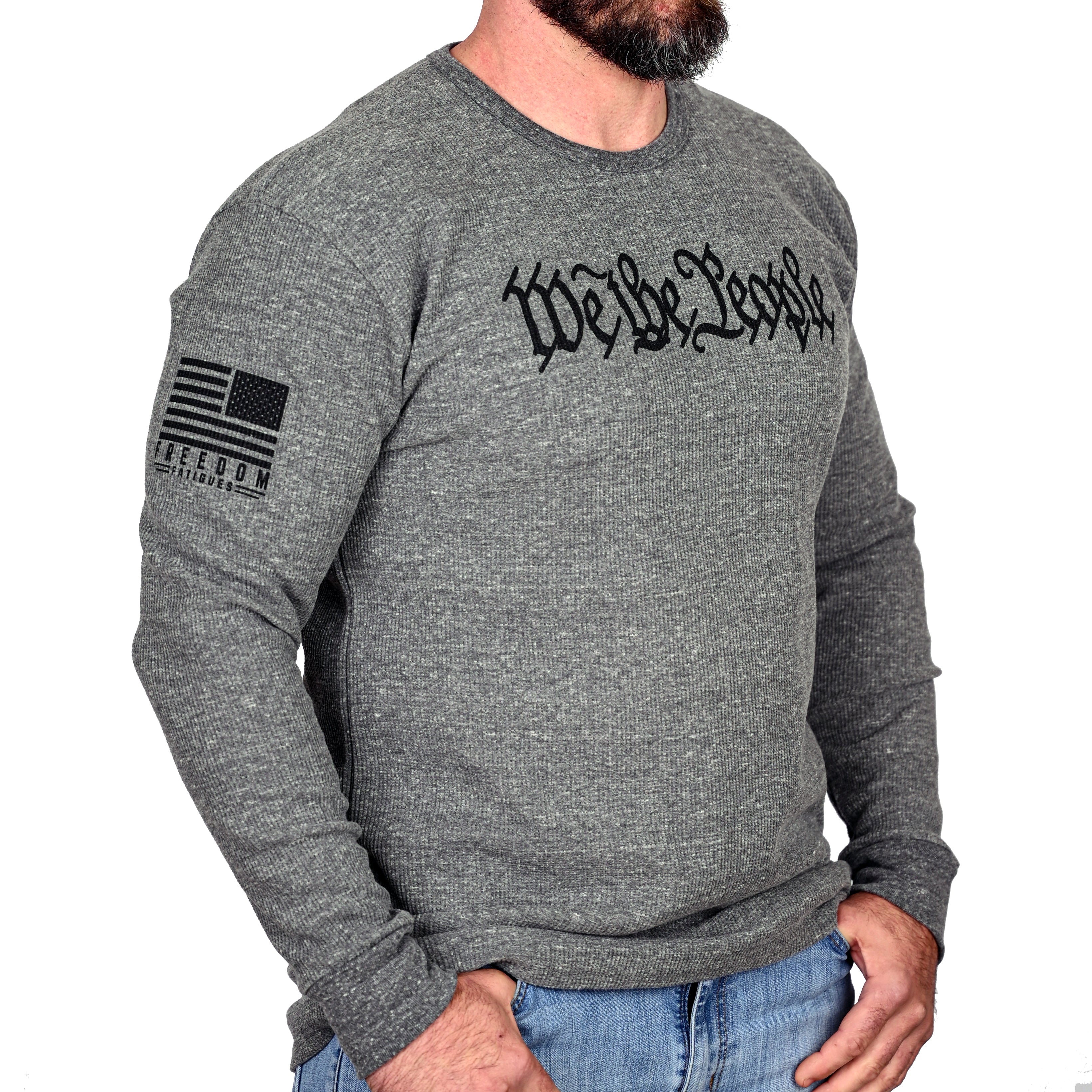 Gray long-sleeve thermal with 'We The People' text and Freedom Fatigues flag on the sleeve and worn by a male model