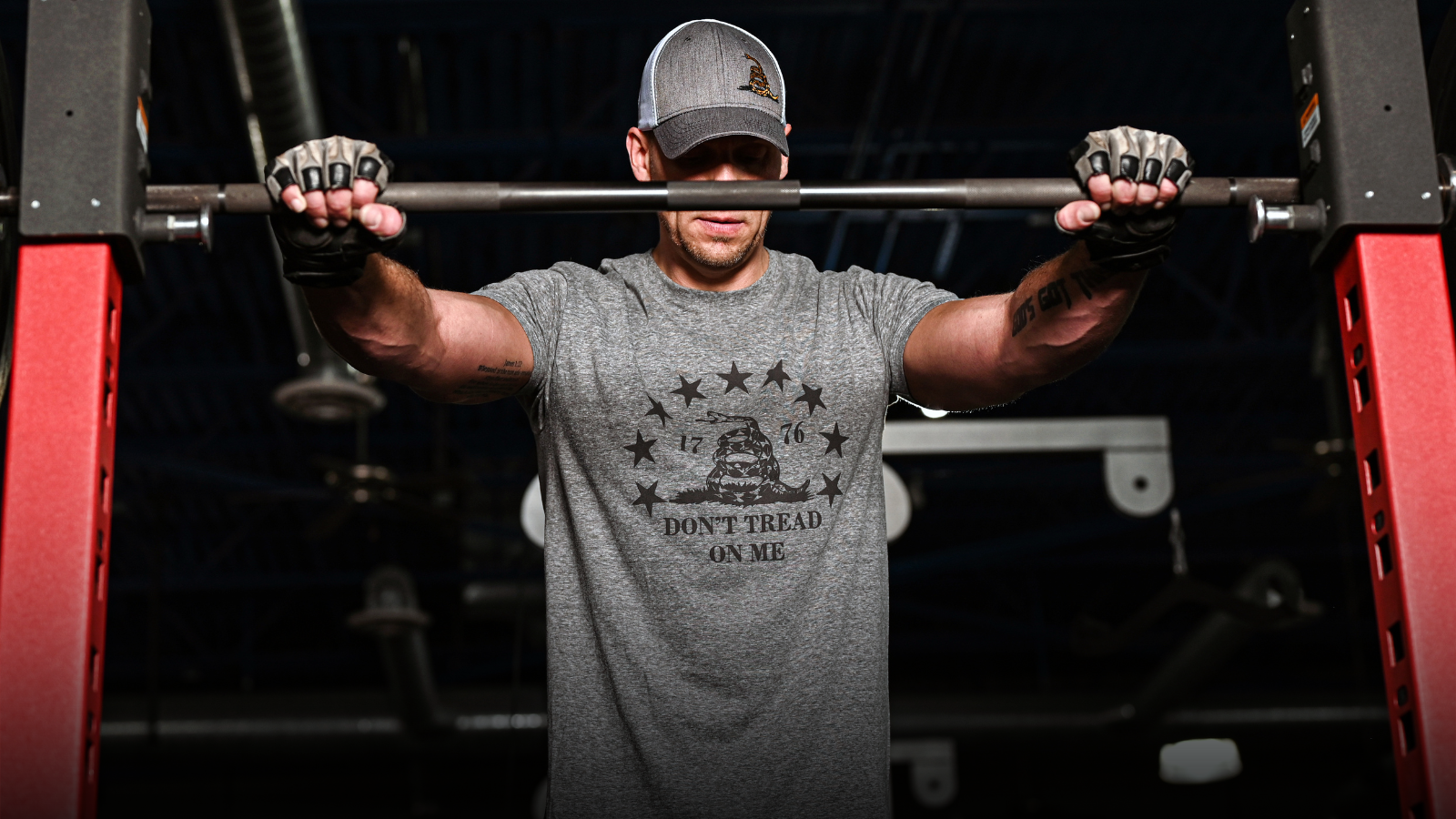 Man lifting a barbell in a gym setting
