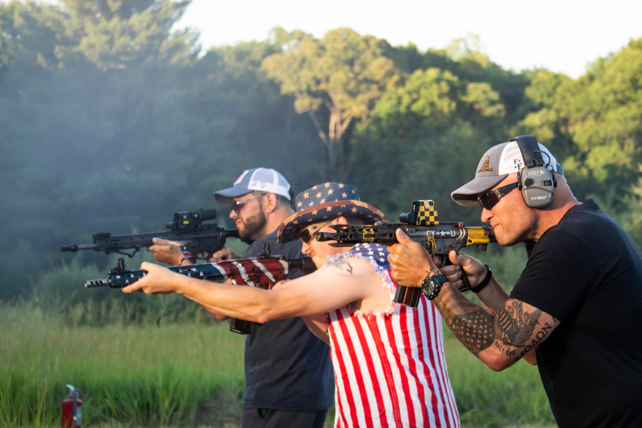 Three men with rifles on a shooting range 