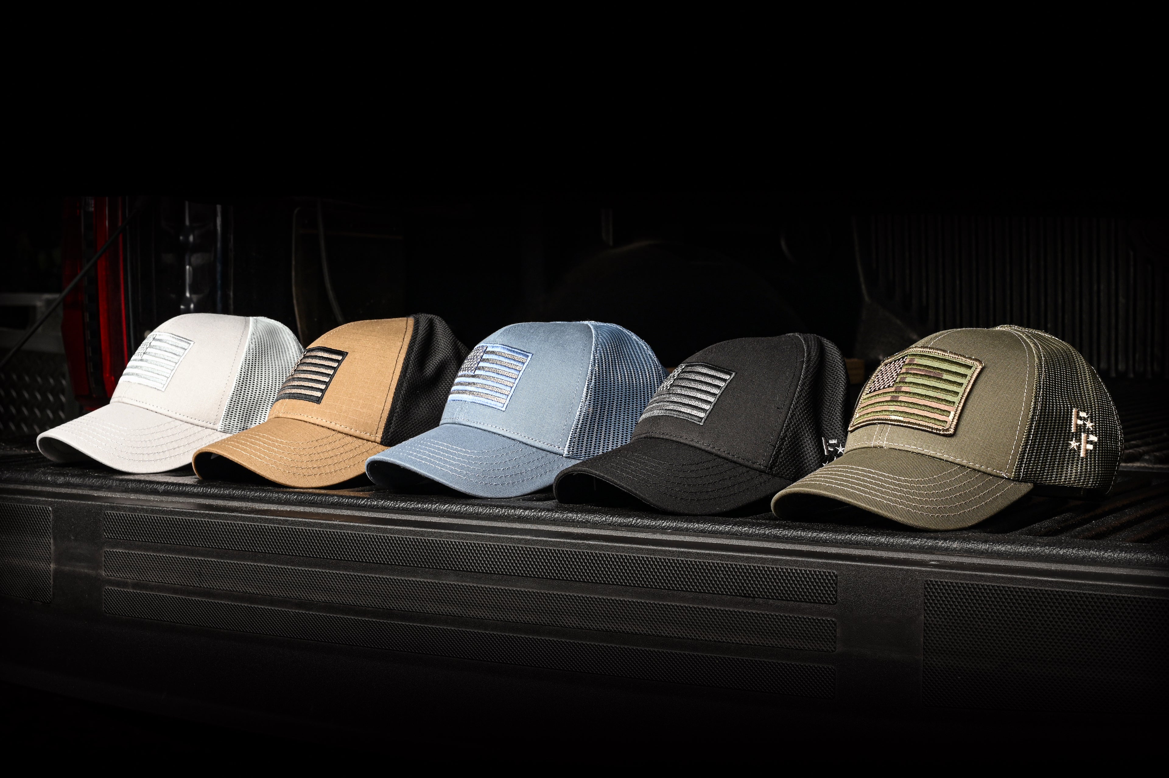 American flag hats displayed on the tailgate of a truck