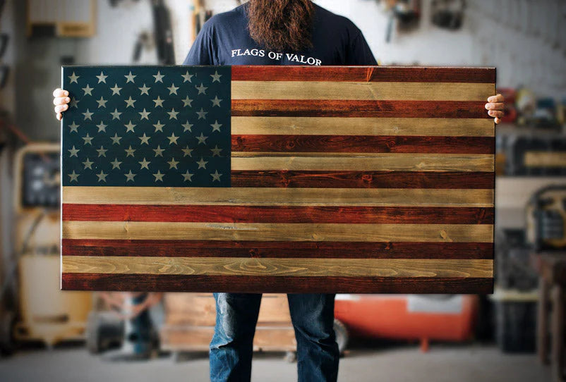 Man holding a handcrafted wooden American flag