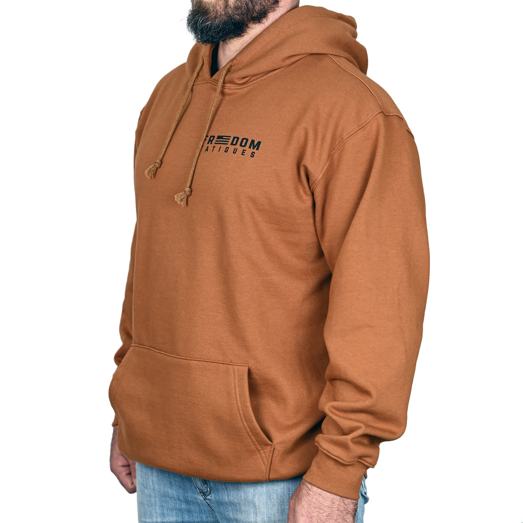 A caramel brown patriotic hoodie with a logo on the chest against worn by a male model