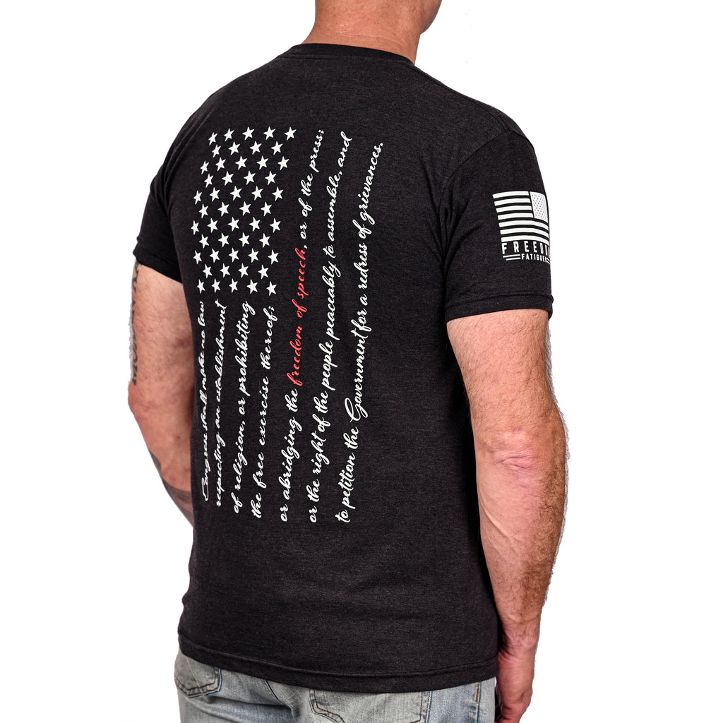 Black triblend t-shirt with an American flag composed of the first amendment text on the back and Freedom Fatigues sleeve print worn by a model.