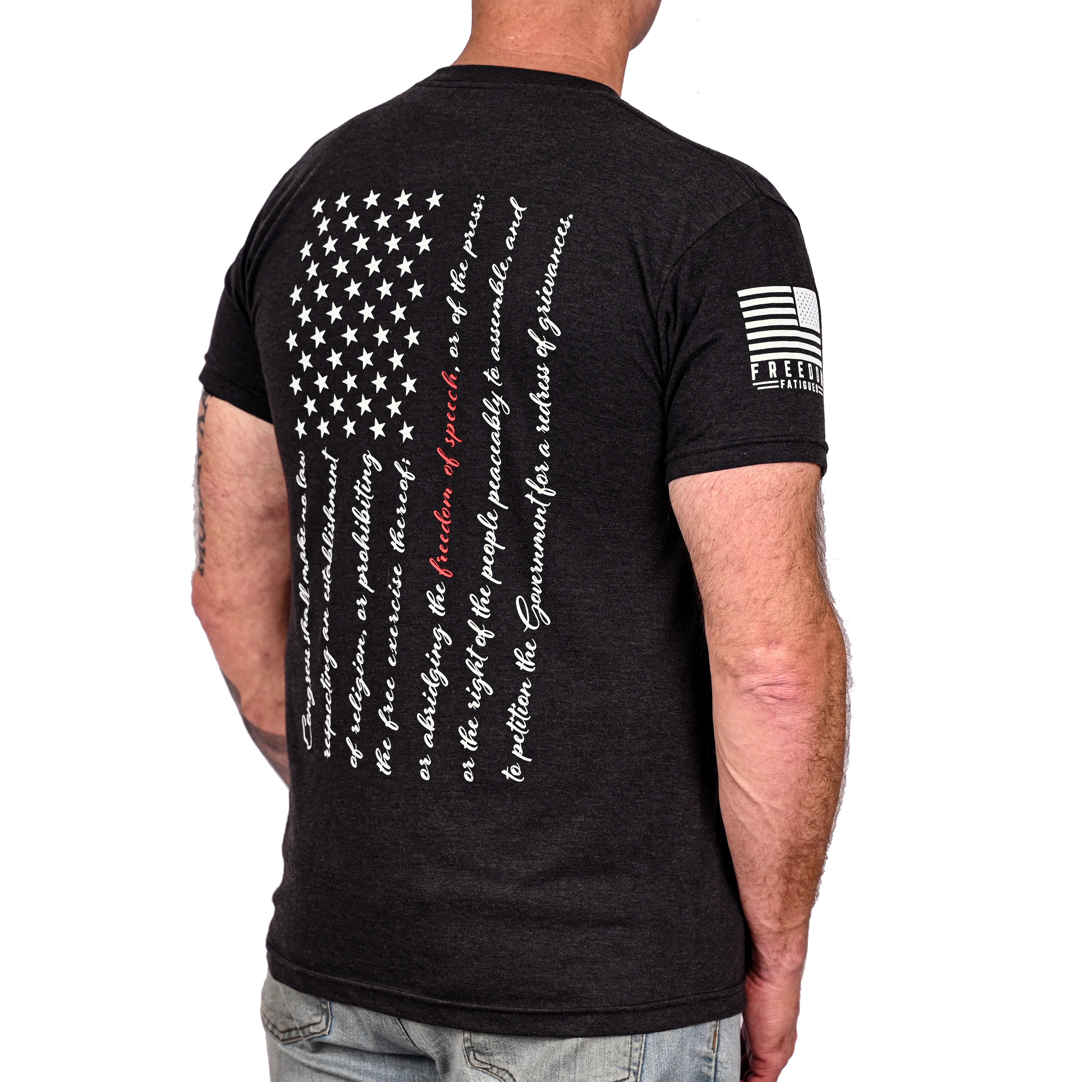 Black triblend t-shirt with an American flag composed of the first amendment text on the back and Freedom Fatigues sleeve print worn by a model.