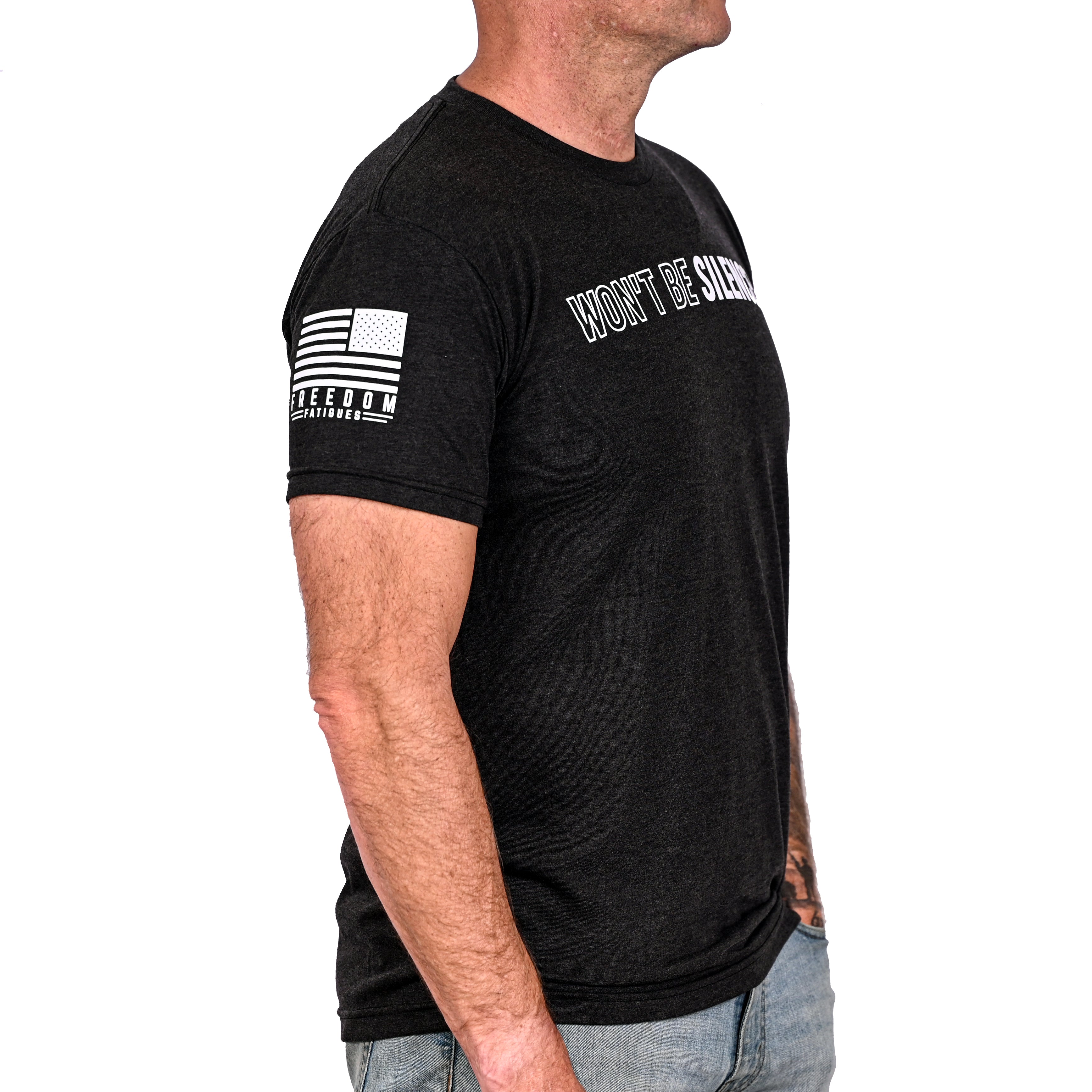 Patriotic black t-shirt with an American flag on the right sleeve and worn by a model.