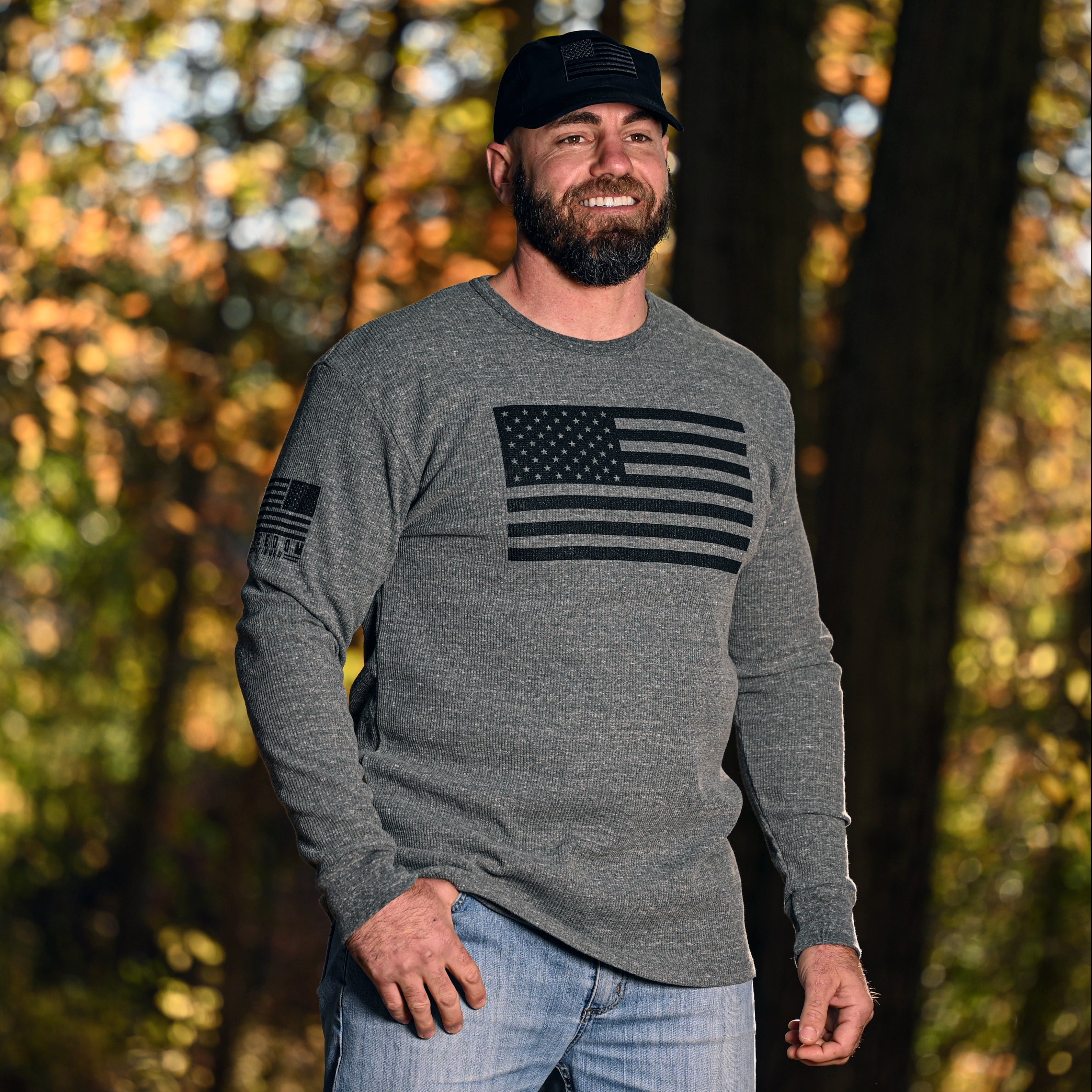 Man wearing the American Flag Long Sleeve Patriotic Thermal in a woodland setting