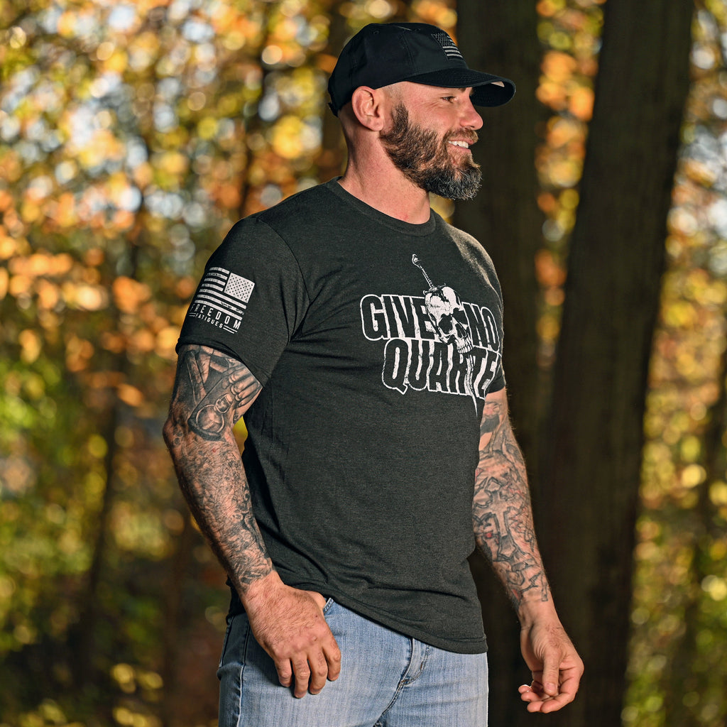 Man wearing the Give No Quarter Patriotic T-shirt in a woodland setting