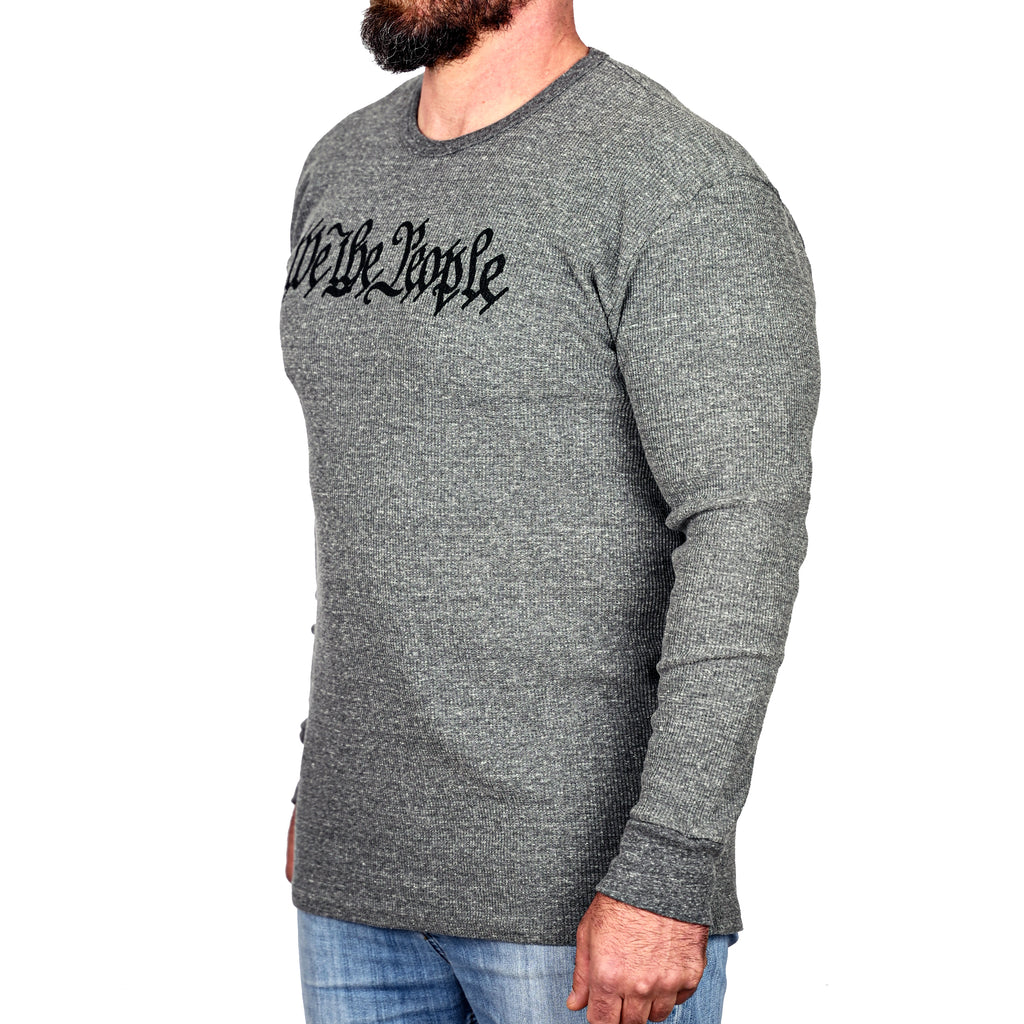 Gray long-sleeve thermal shirt with 'We the People' on the front and worn by a male model