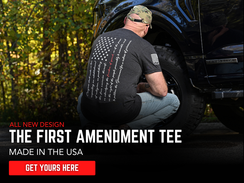 Man working on a vehicle wearing The First Amendment Tee , made in the USA