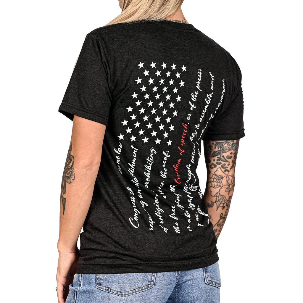 Patriotic black t-shirt with an American flag composed of the first amendment on the back and worn by a female model.