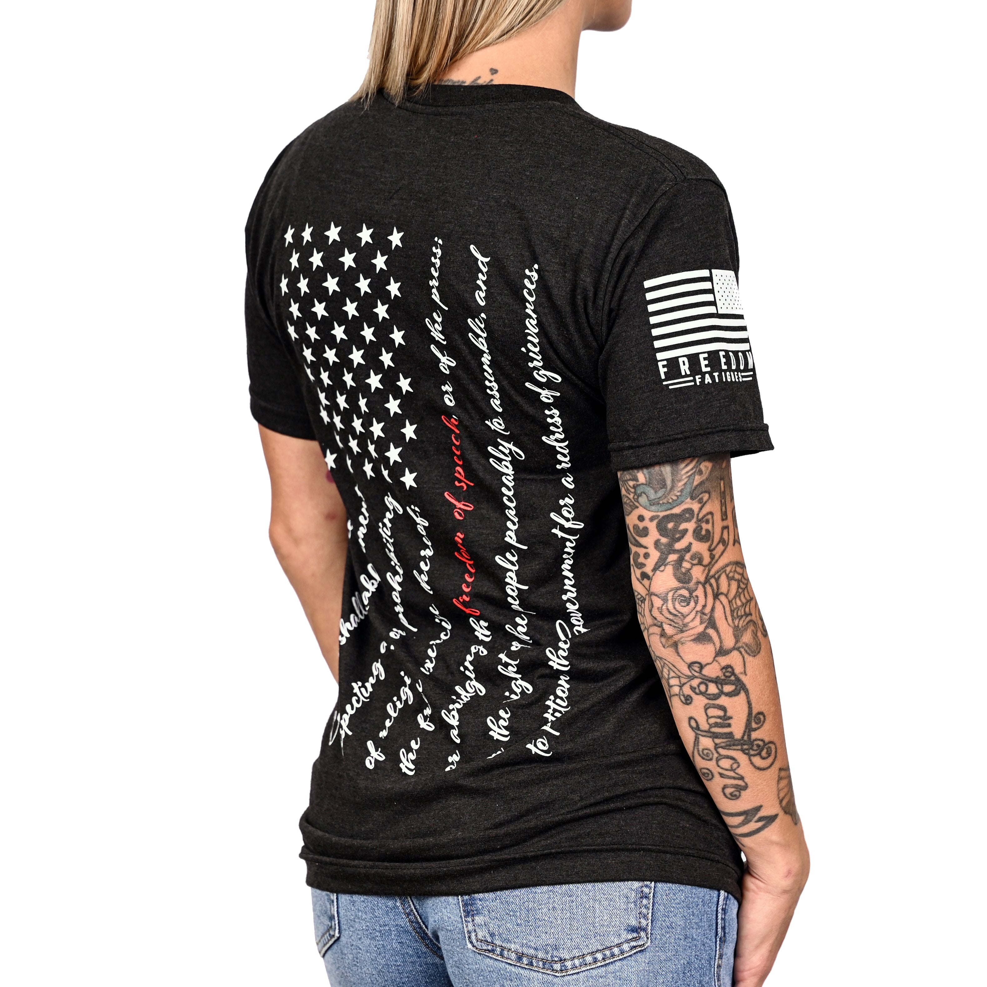 Patriotic black t-shirt with an American flag composed of the first amendment on the back and a Freedom Fatigues sleeve print worn by a female model.