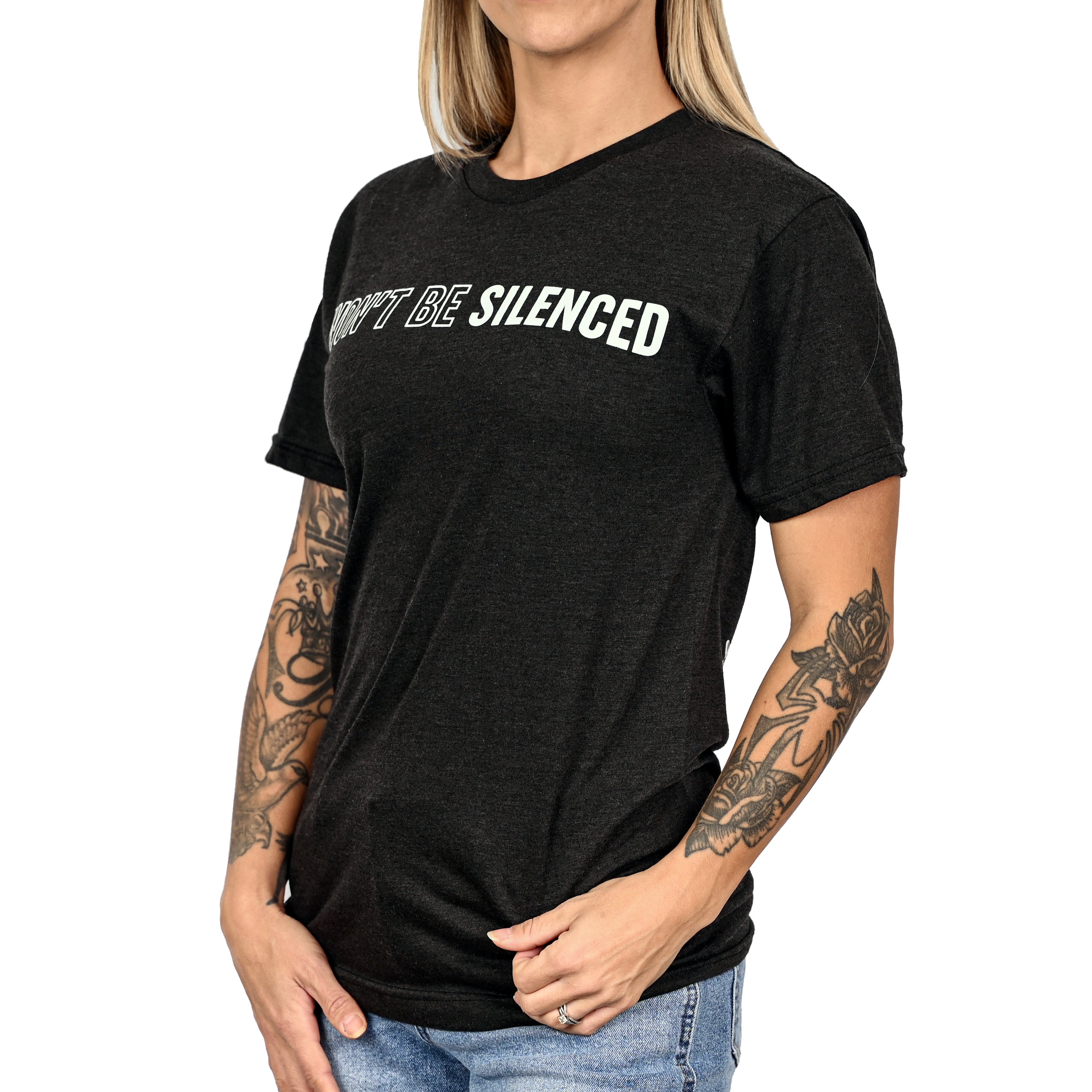 Woman wearing a patriotic black t-shirt by Freedom Fatigues with 'WON'T BE SILENCED' text on the front.