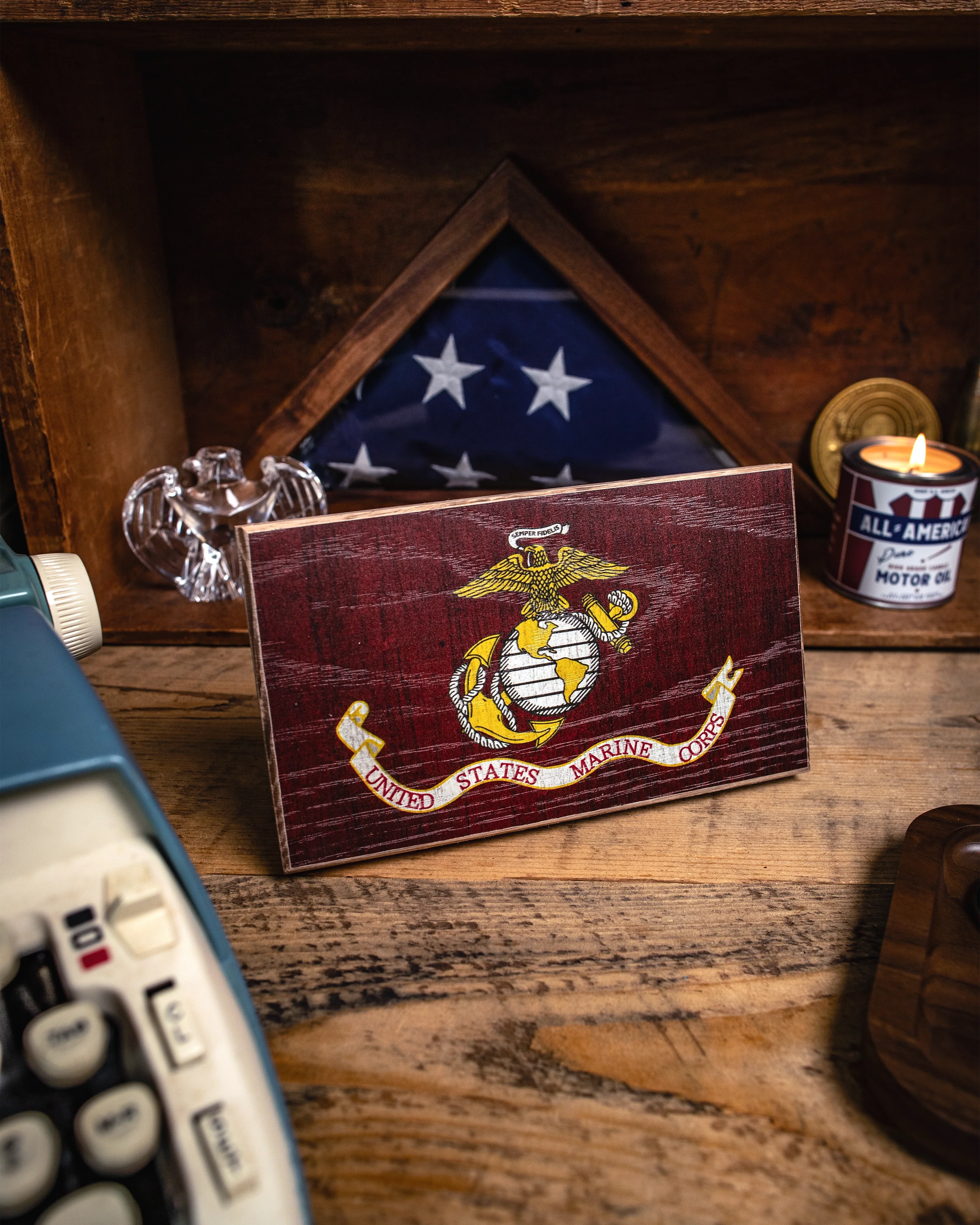 Maroon card with U.S. Marine Corps emblem on a wooden surface