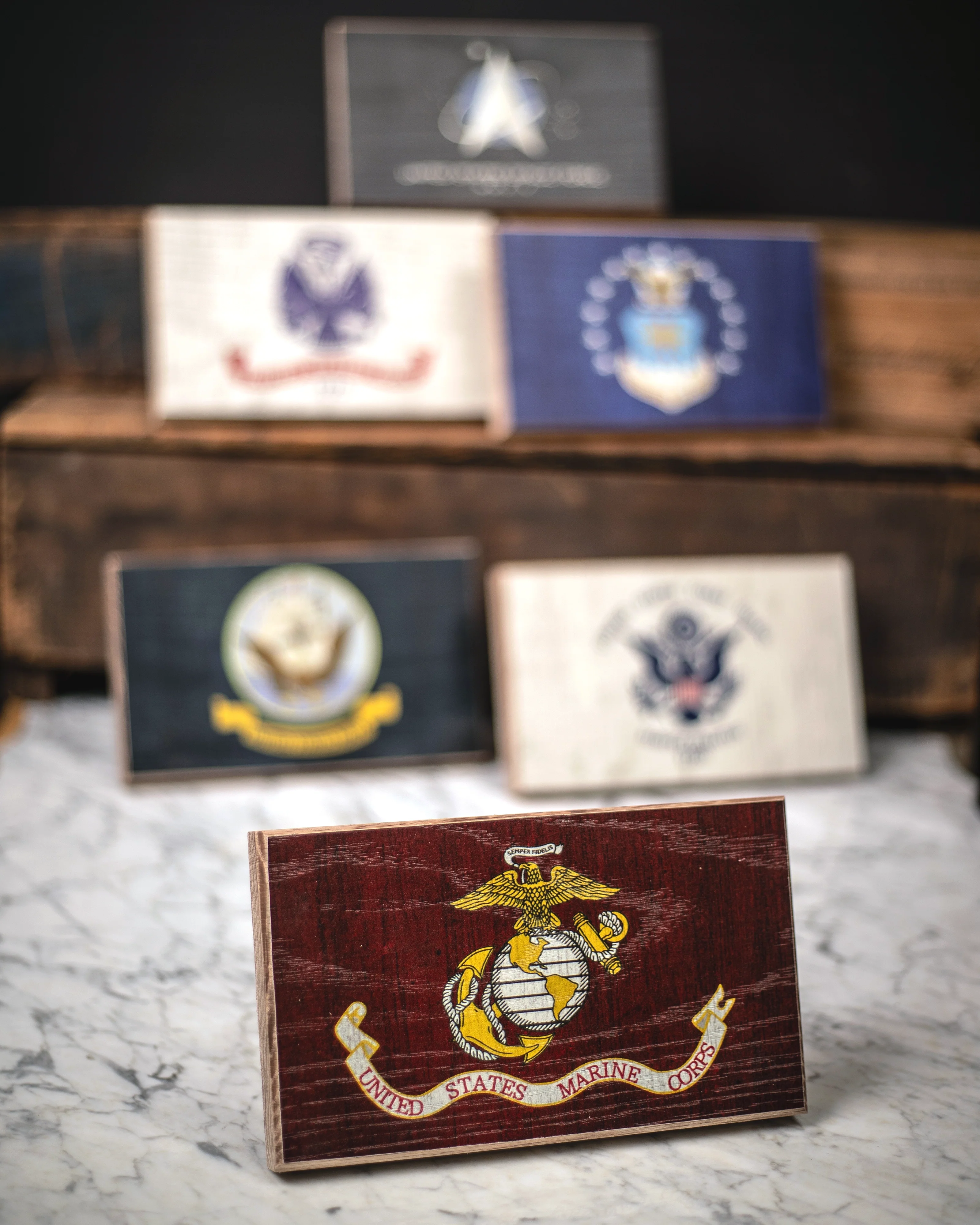 Collection of military emblems on wooden and marble surfaces