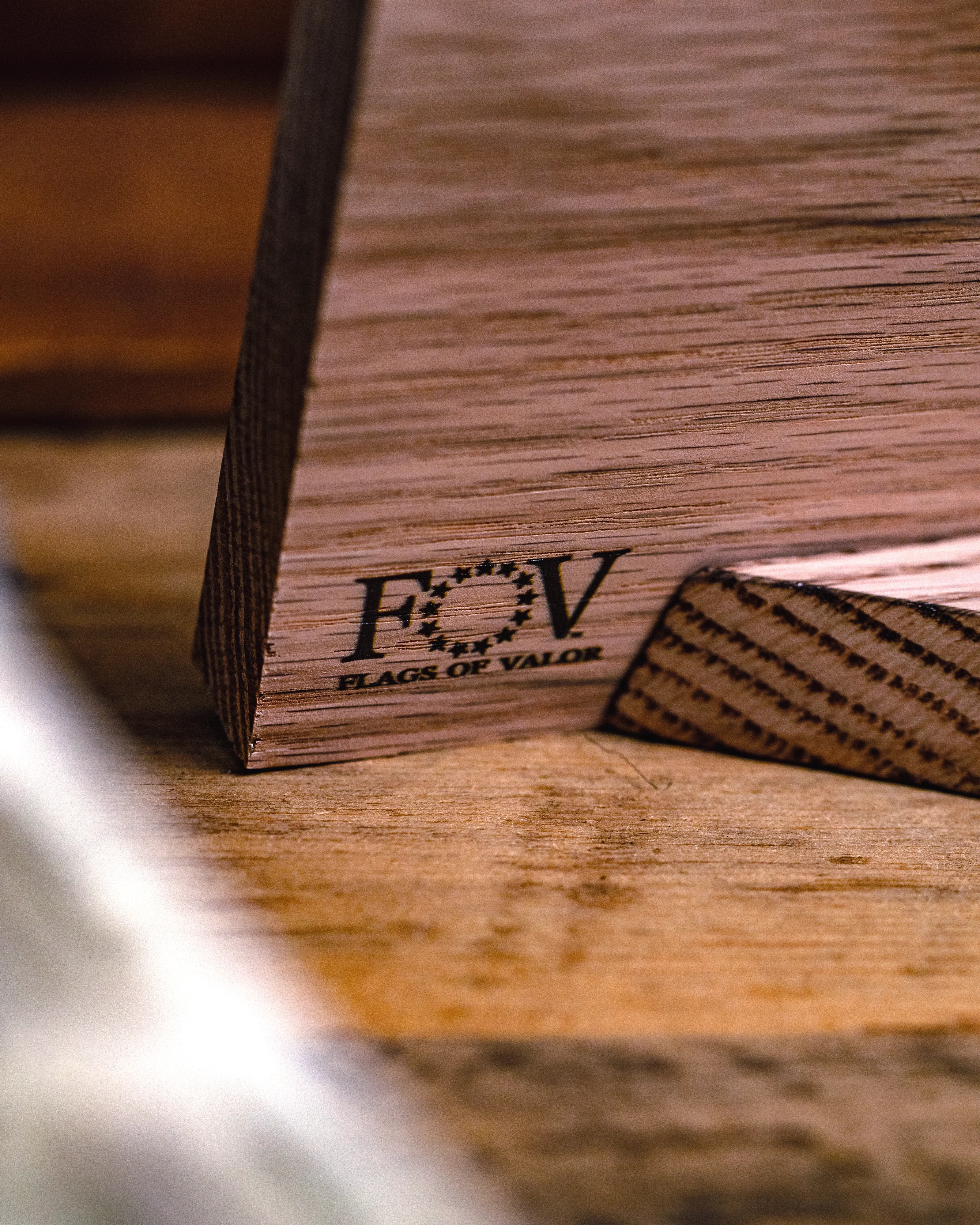 Wooden product with 'FOV' branding on a wooden surface